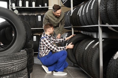Photo of Service center consultant helping customer to choose tire in store