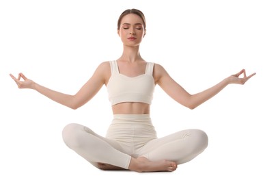 Beautiful young woman meditating on white background