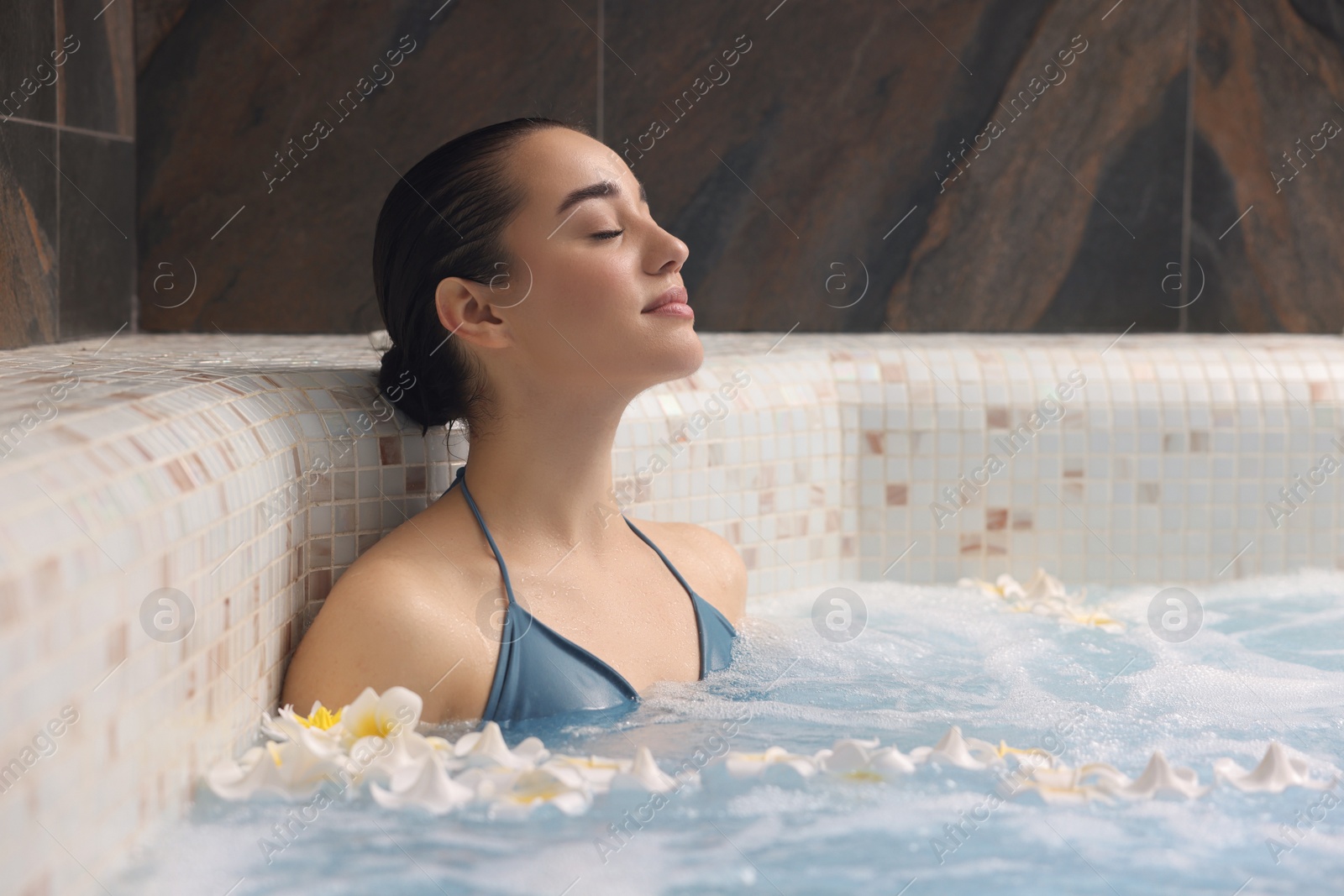 Photo of Beautiful woman relaxing in spa swimming pool, space for text