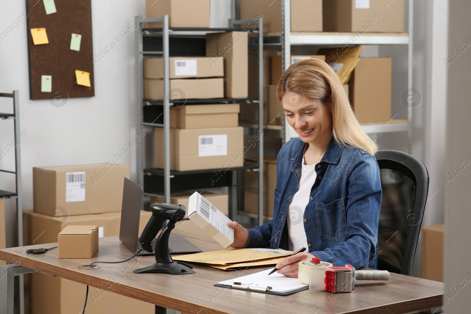 Photo of Seller with parcel in office. Online store