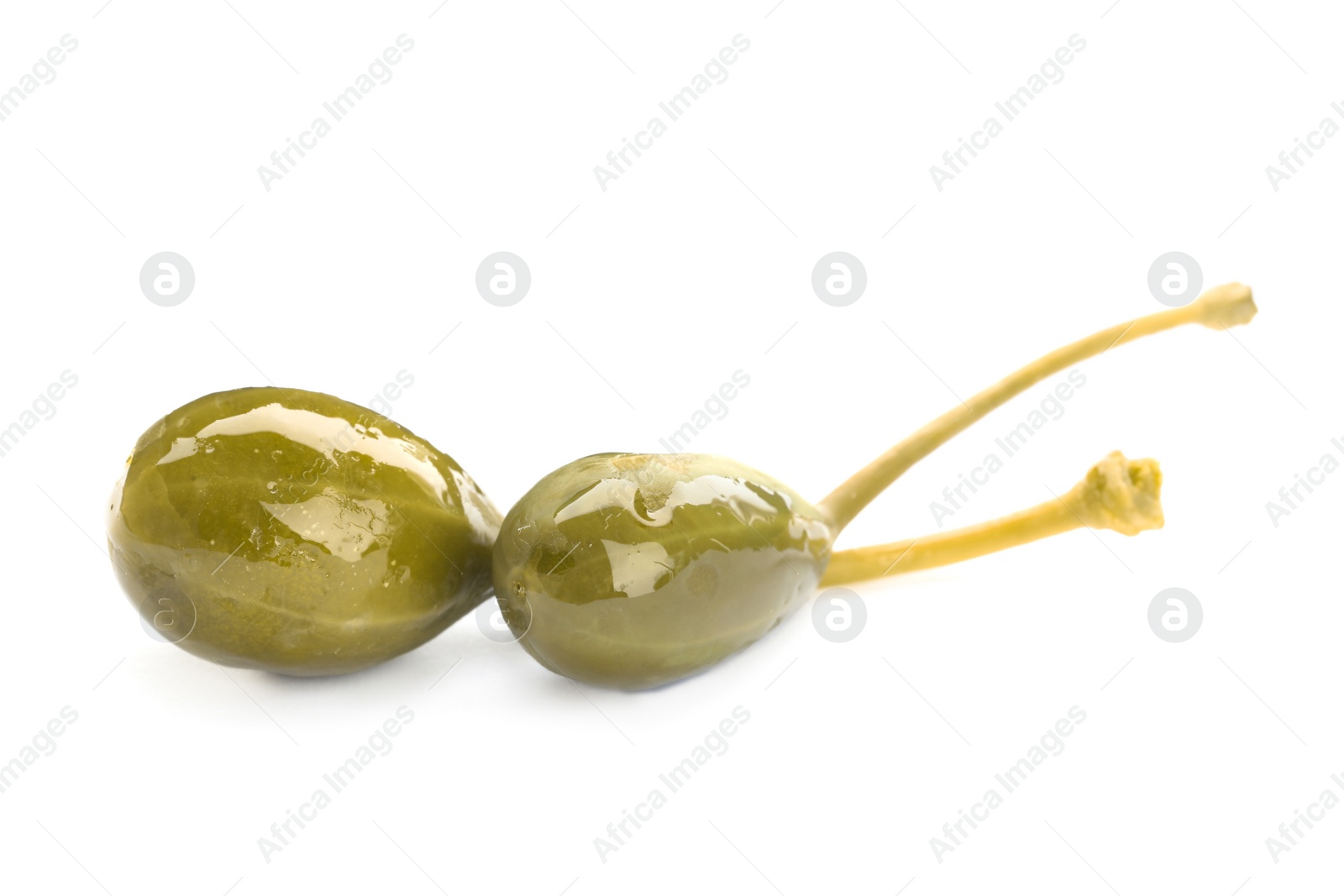 Photo of Two delicious pickled capers on white background