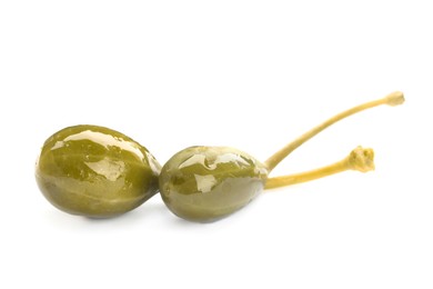 Photo of Two delicious pickled capers on white background