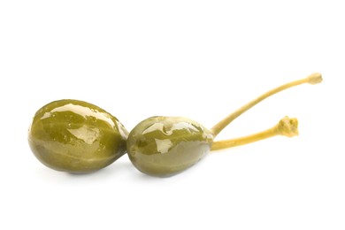 Two delicious pickled capers on white background