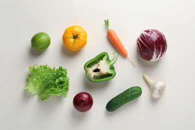 Photo of Flat lay composition with fresh vegetables and fruit on color background