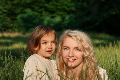 Photo of Happy mother with her cute daughter spending time together outdoors