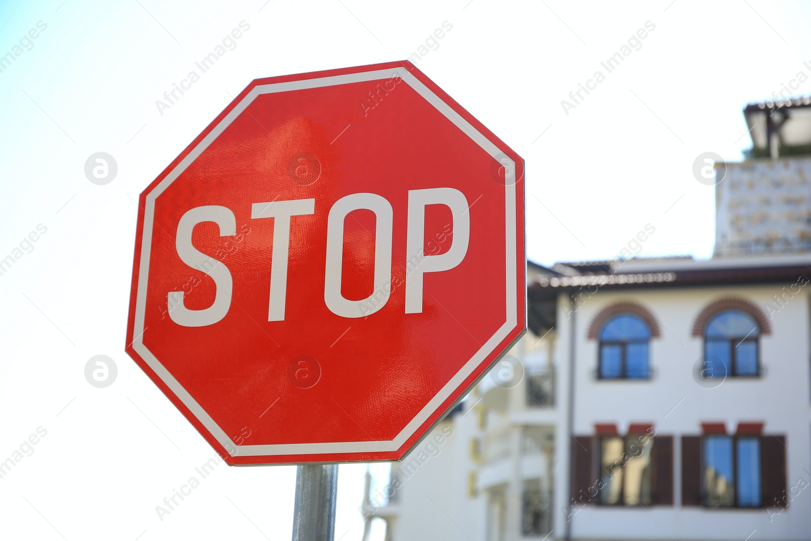 Photo of Post with Stop sign on city street