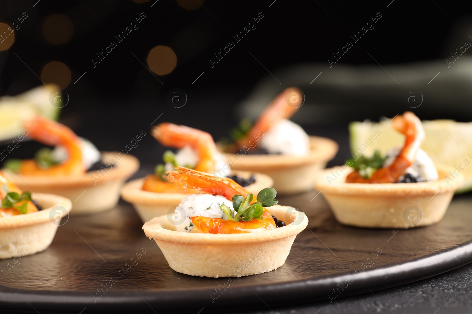 Photo of Delicious canapes with shrimps and black caviar on table, closeup