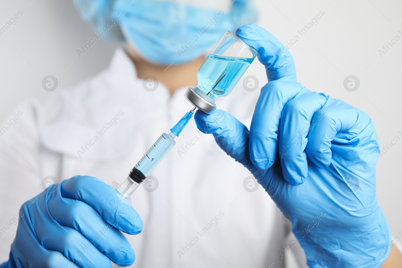 Photo of Doctor filling syringe with medication, closeup. Vaccination and immunization