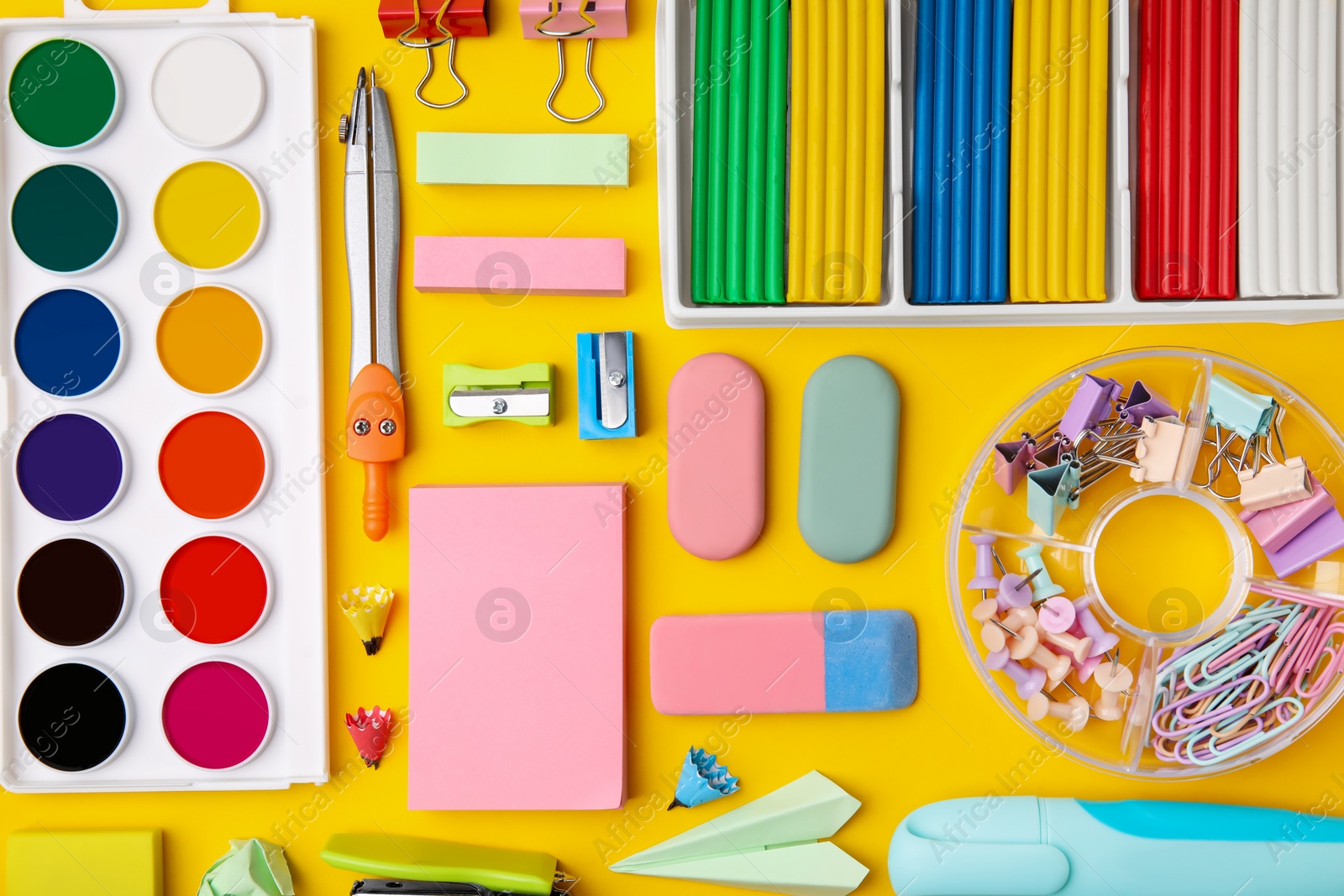 Photo of Many different school stationery on yellow background, flat lay. Back to school