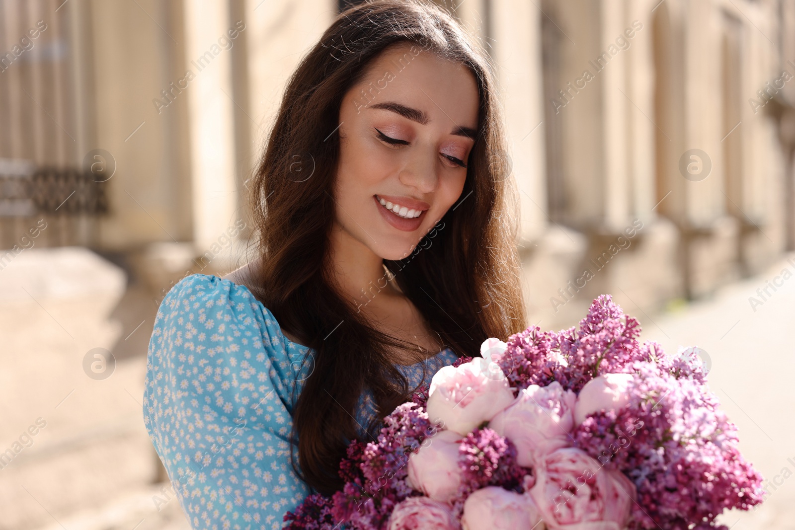 Photo of Beautiful woman with bouquet of spring flowers outdoors