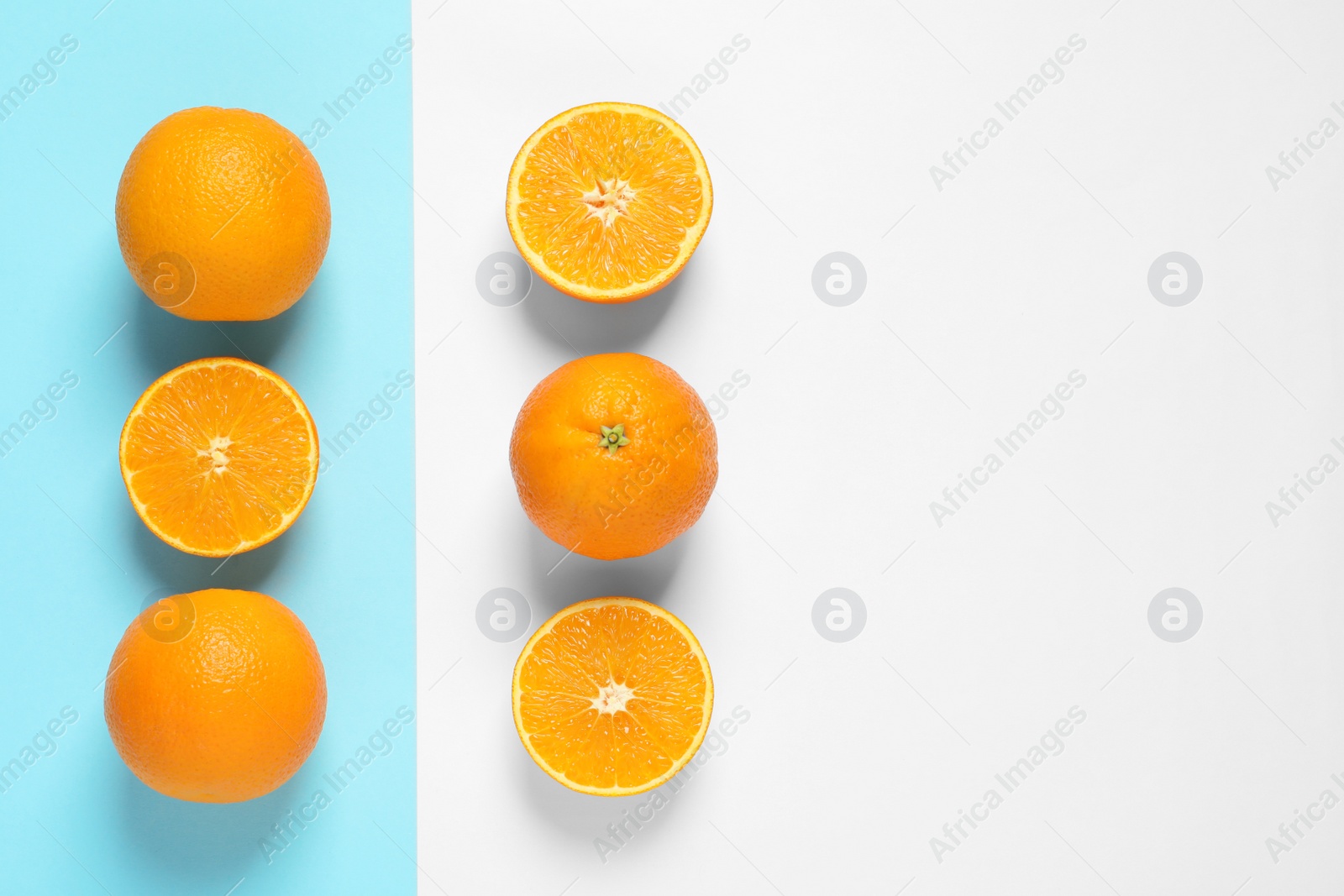 Photo of Flat lay composition with ripe oranges and space for text on color background