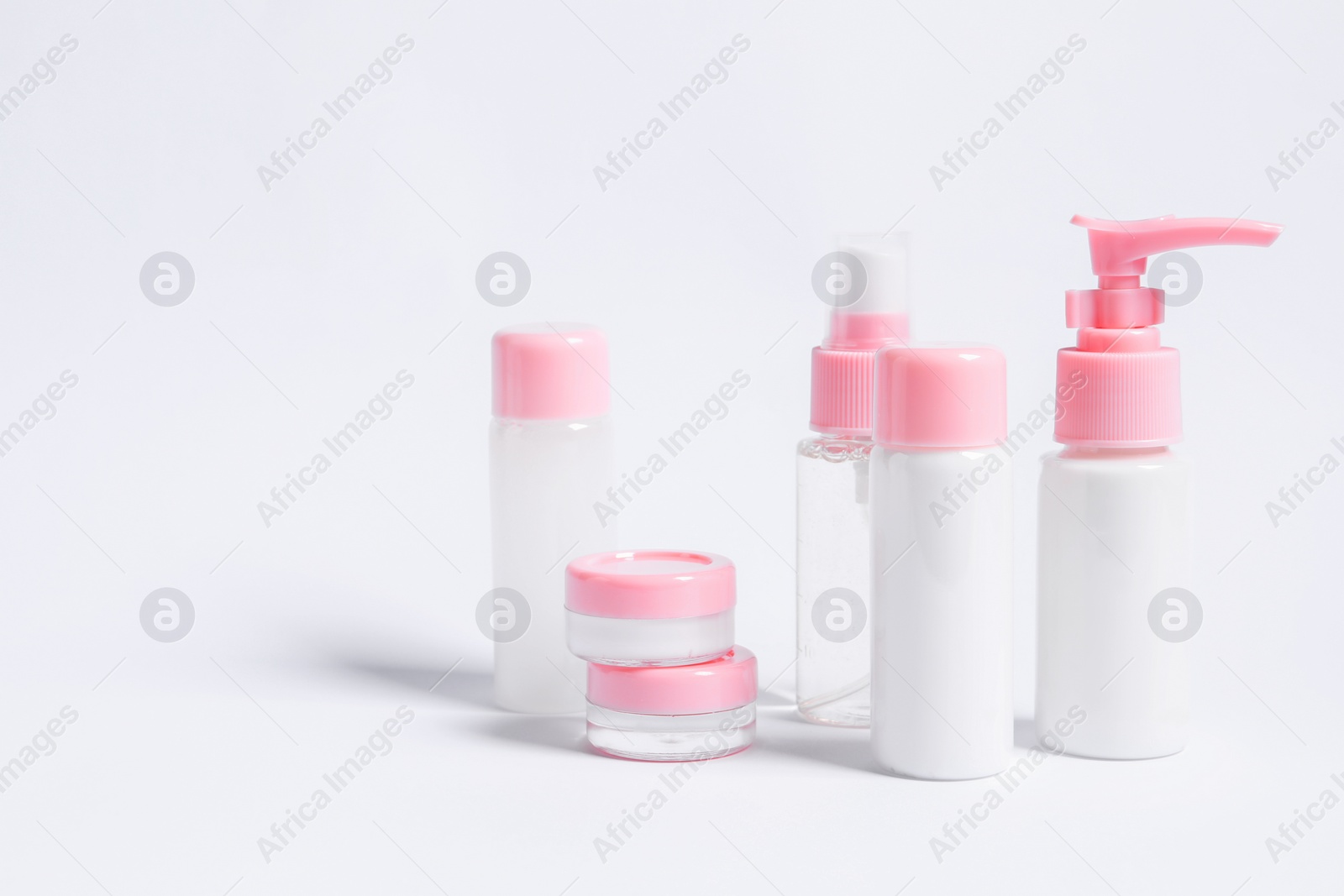 Photo of Cosmetic travel kit on white background. Space for text