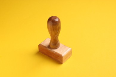 One wooden stamp tool on yellow background