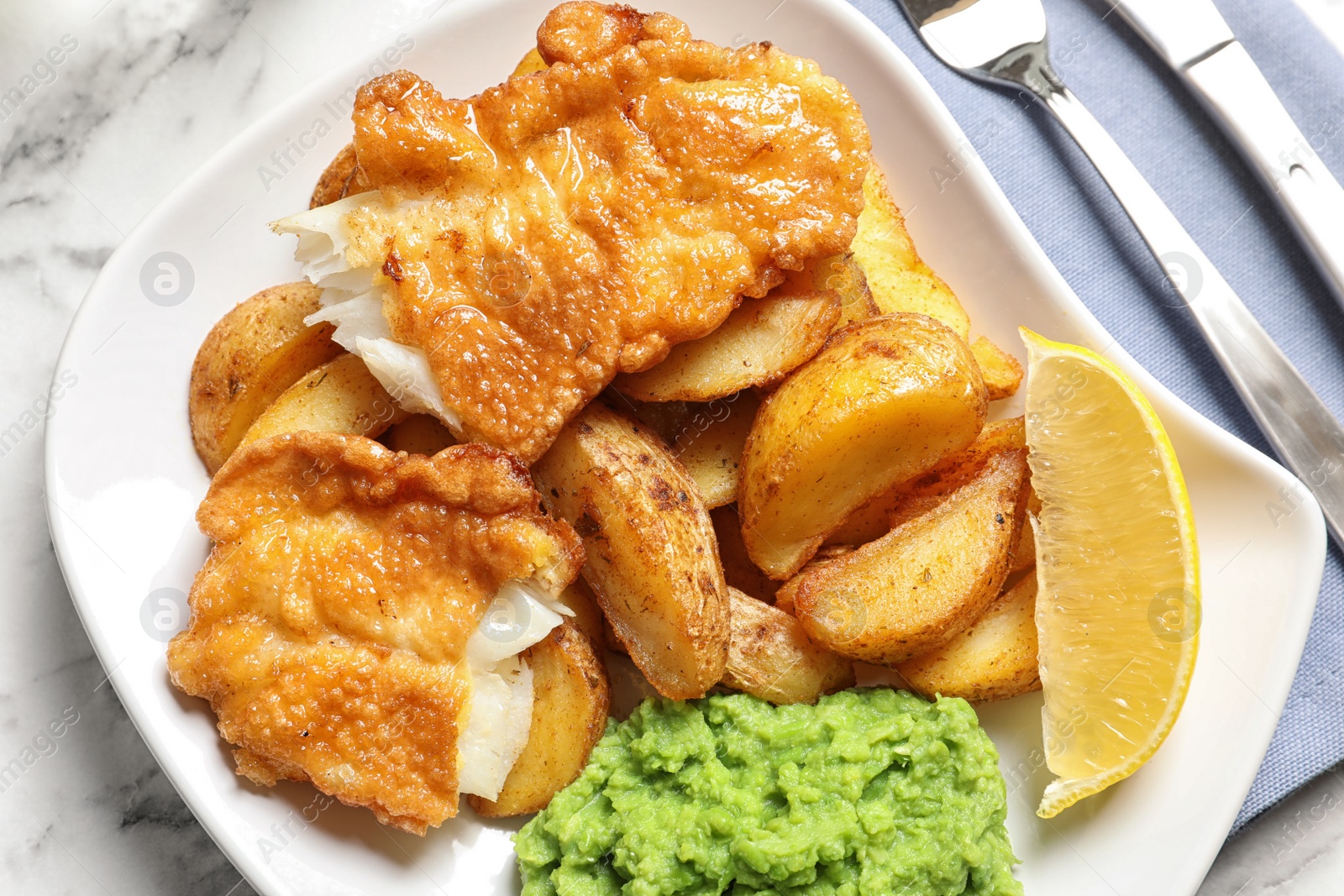 Photo of Plate with British traditional fish and potato chips, top view