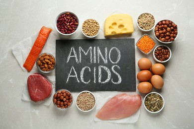 Photo of Flat lay composition with products rich in amino acids on light grey table