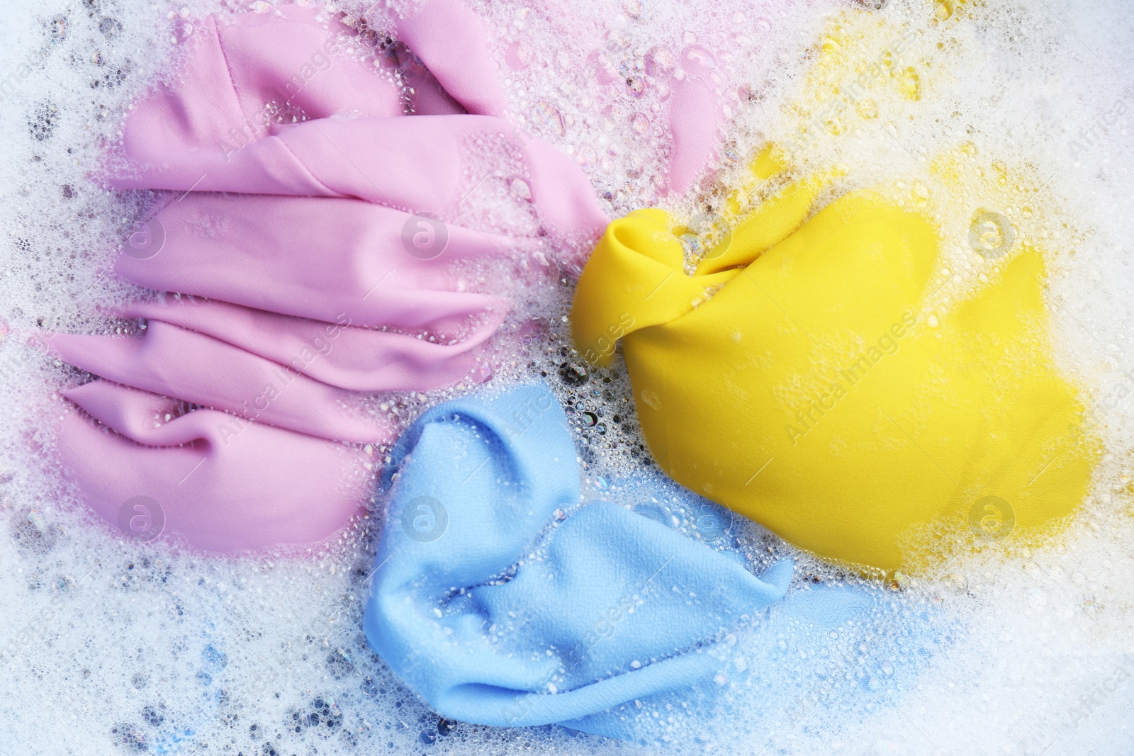 Photo of Color clothing in suds, top view. Hand washing laundry