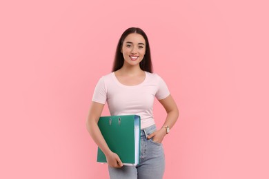 Photo of Happy woman with folder on pink background