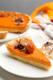 Photo of Slice of delicious homemade pumpkin pie on plate, closeup
