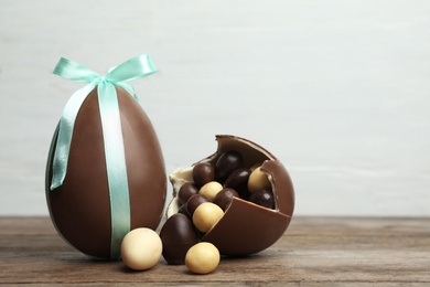 Photo of Composition with chocolate Easter eggs on table against light background. Space for text