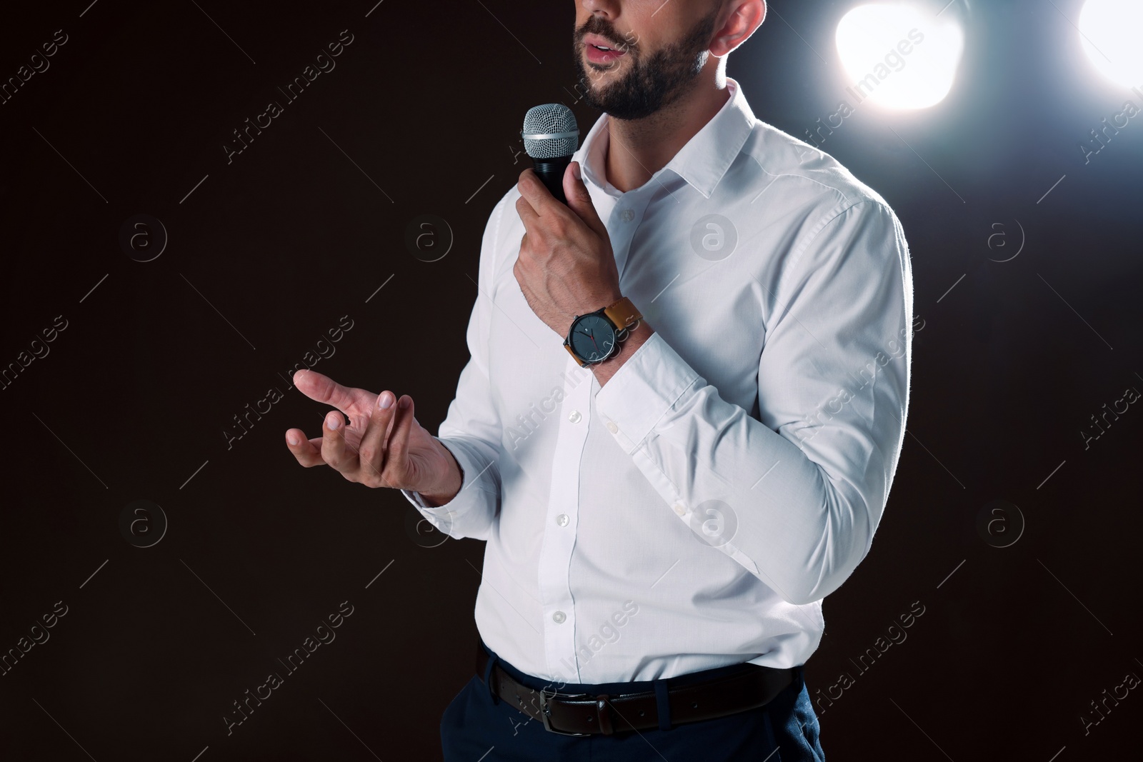 Photo of Motivational speaker with microphone performing on stage, closeup