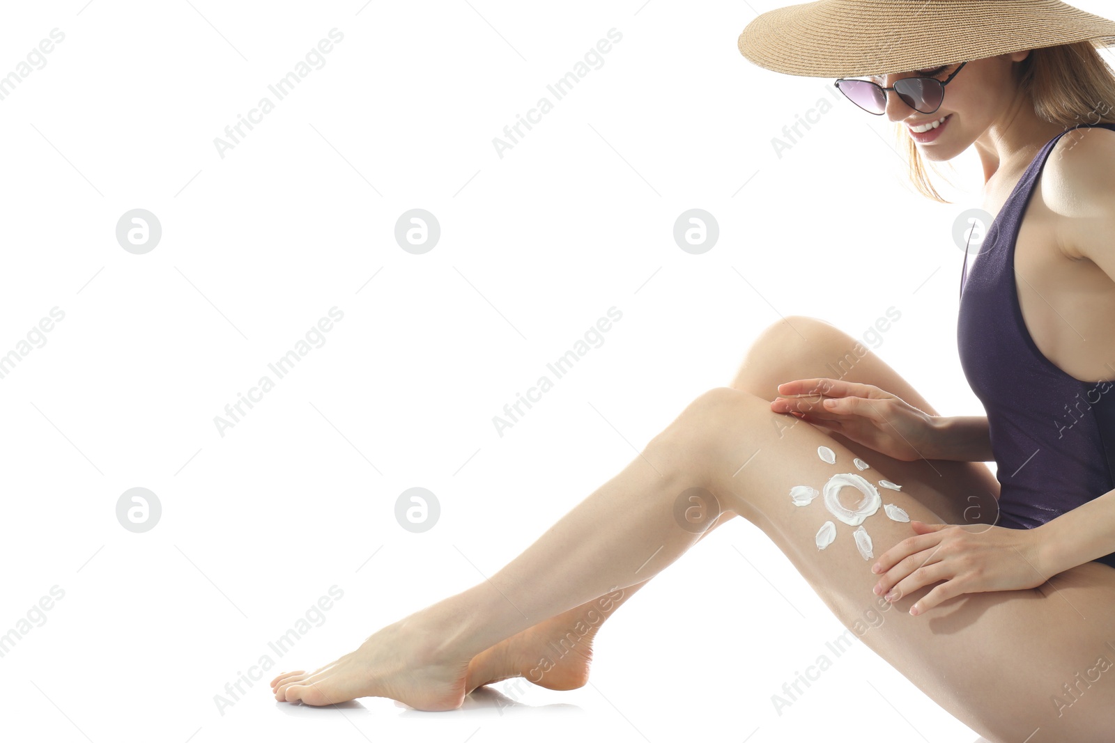 Photo of Woman applying sun protection cream on leg against white background