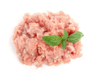 Photo of Pile of raw chicken minced meat with basil on white background, top view