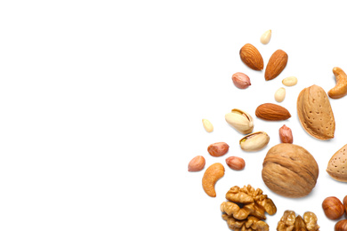 Photo of Different delicious nuts on white background, flat lay. Space for text