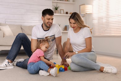 Family with little daughter spending time together at home