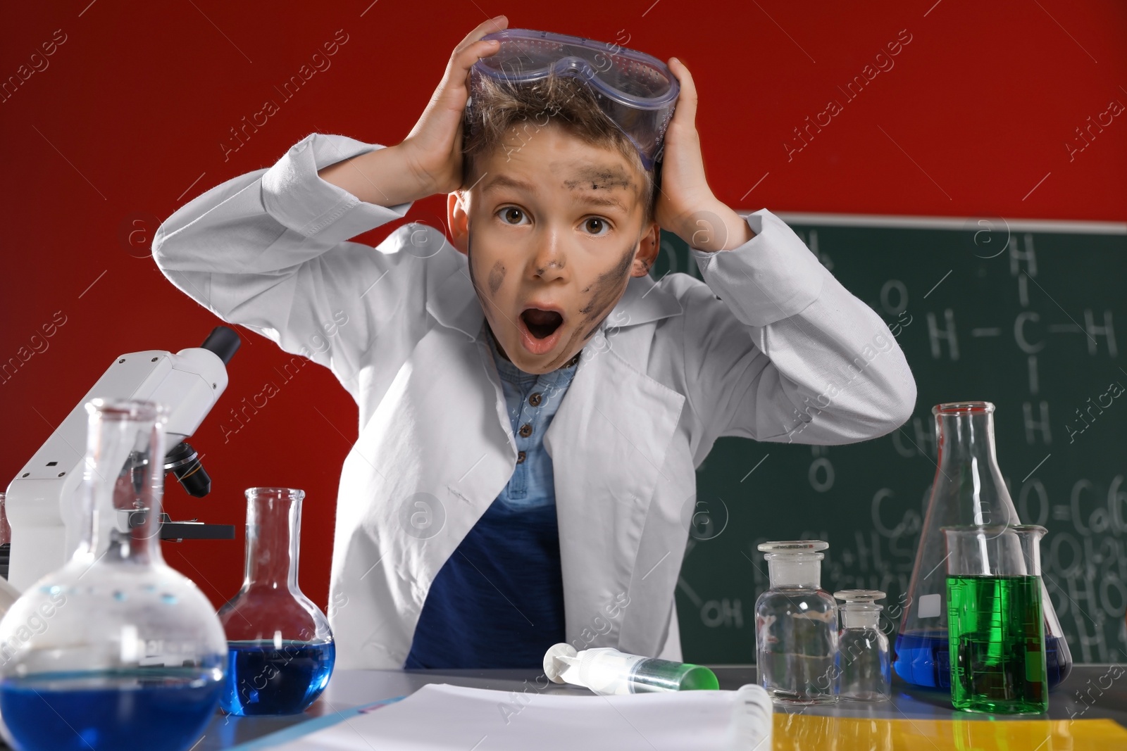 Photo of Emotional child in laboratory after explosion. Dangerous experiment