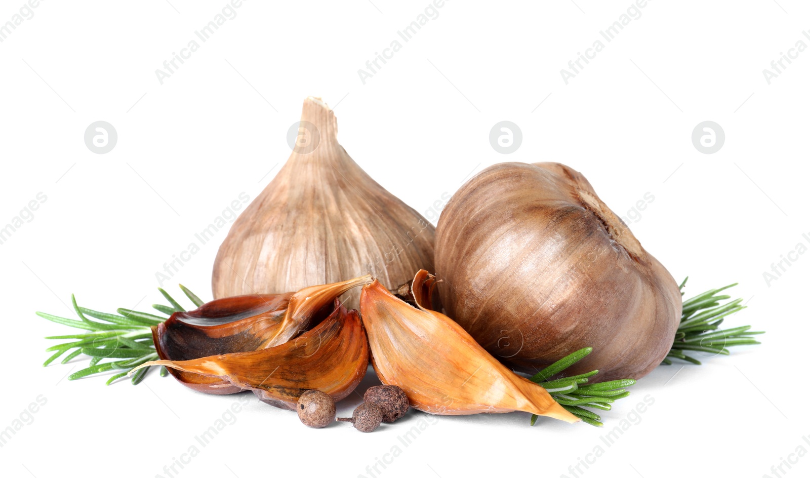 Photo of Aged black garlic with rosemary on white background