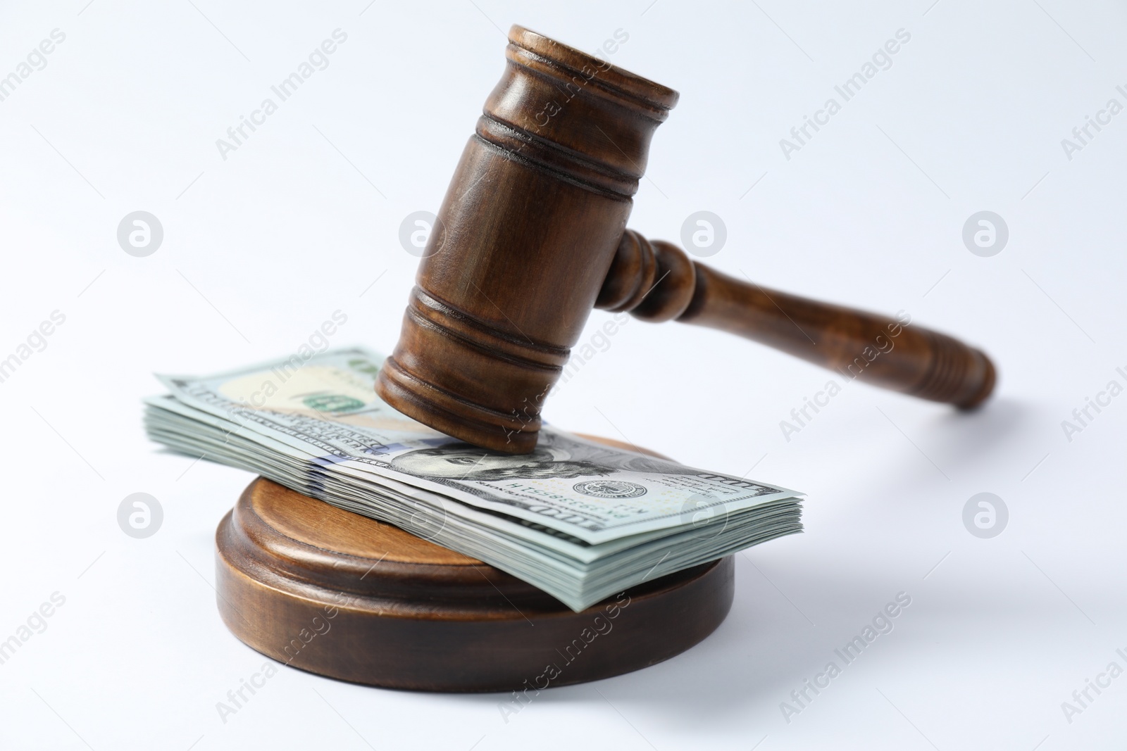 Photo of Law gavel with stack of dollars on white background