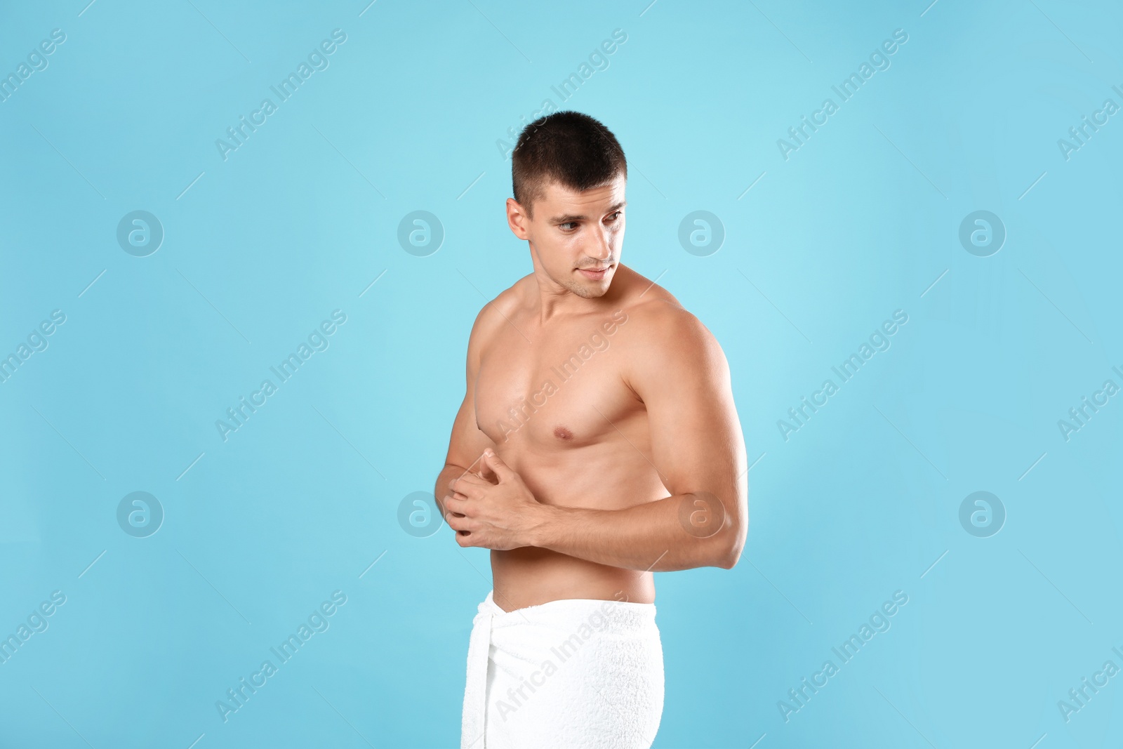 Photo of Young man with slim body on light blue background