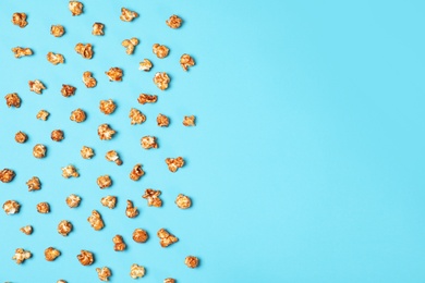 Photo of Flat lay composition with caramel popcorn and space for text on color background