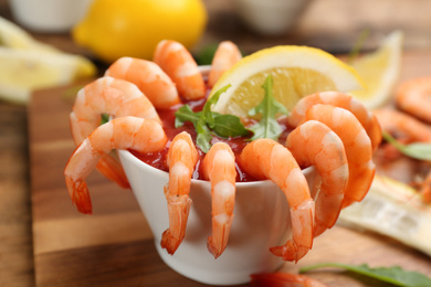 Photo of Delicious shrimp cocktail served on board, closeup