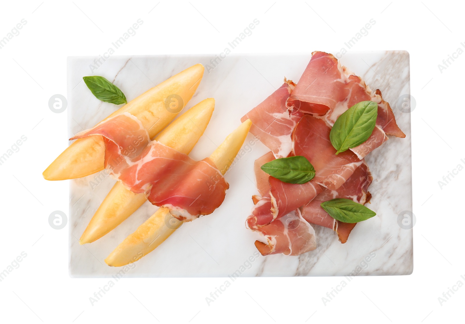 Photo of Board with melon slices and prosciutto on white background, top view