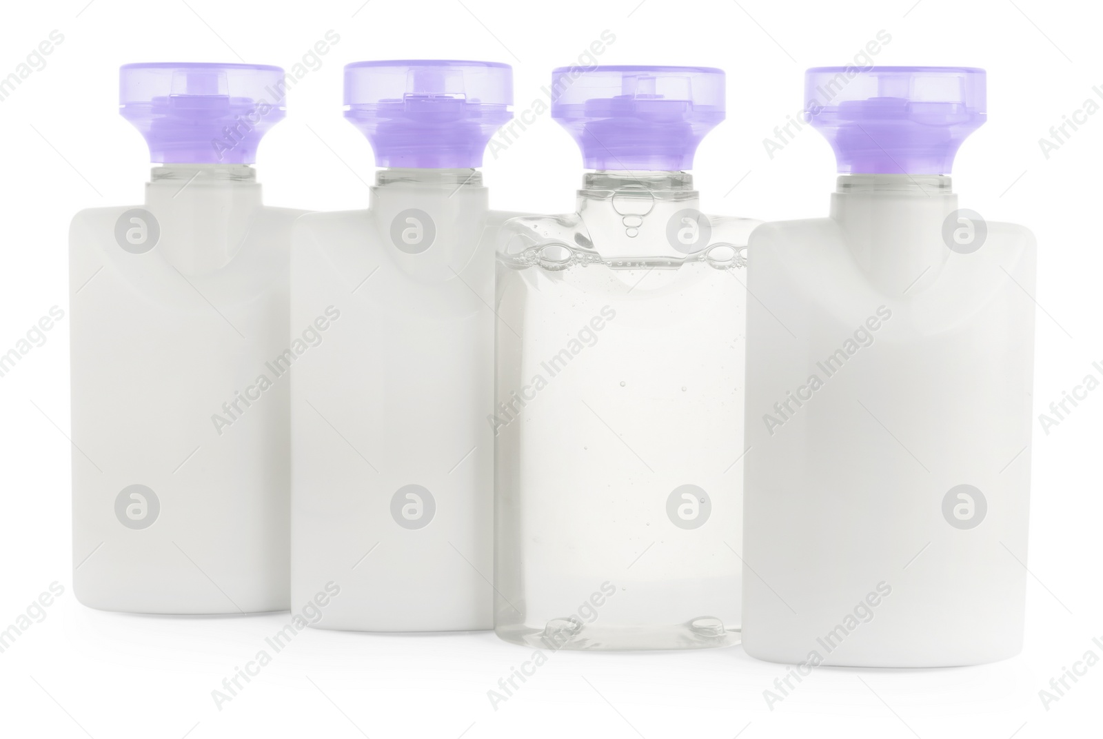 Photo of Mini bottles of cosmetic products isolated on white