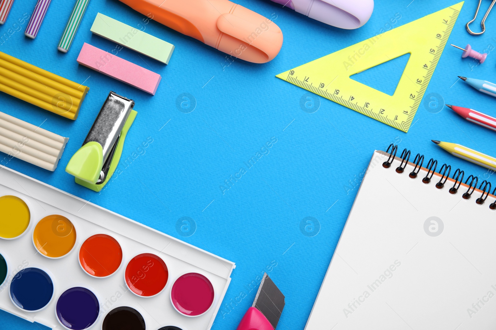 Photo of Different school stationery on light blue background, flat lay with space for text. Back to school