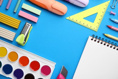 Photo of Different school stationery on light blue background, flat lay with space for text. Back to school