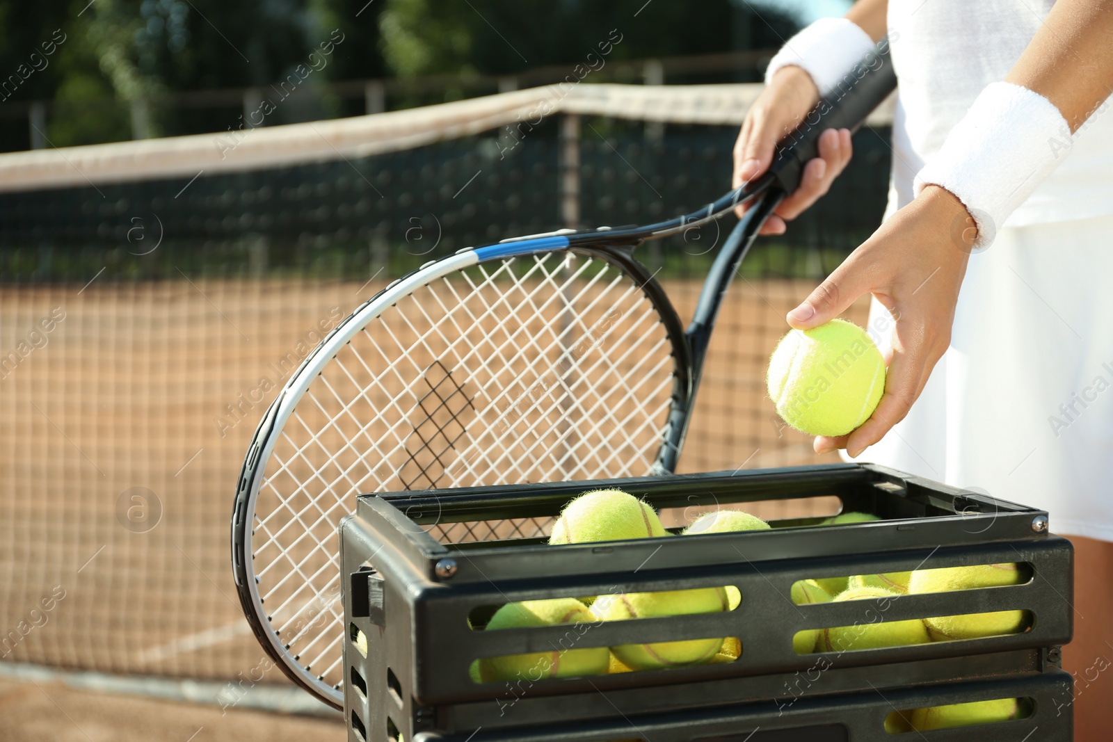 Photo of Sportswoman playing tennis at court on sunny day, closeup