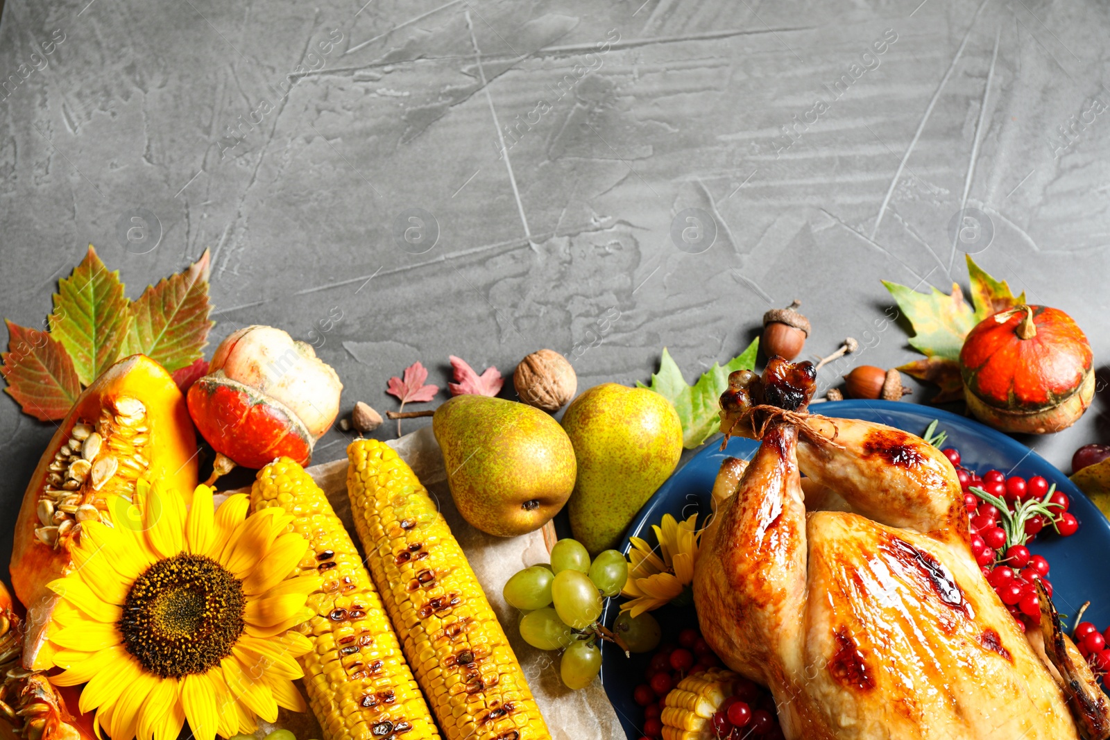 Photo of Flat lay composition with delicious turkey on grey background, space for text. Happy Thanksgiving day