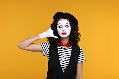 Photo of Funny mine with beret posing on orange background