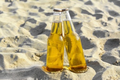 Photo of Bottles of cold beer on sandy beach