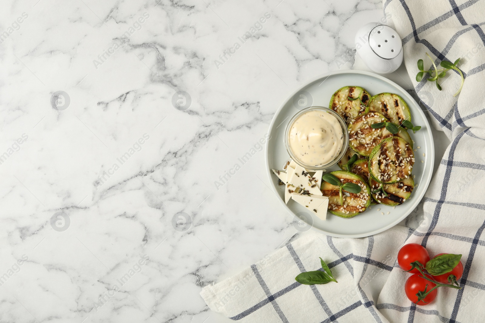 Photo of Flat lay composition with delicious grilled zucchini slices on white marble table, space for text