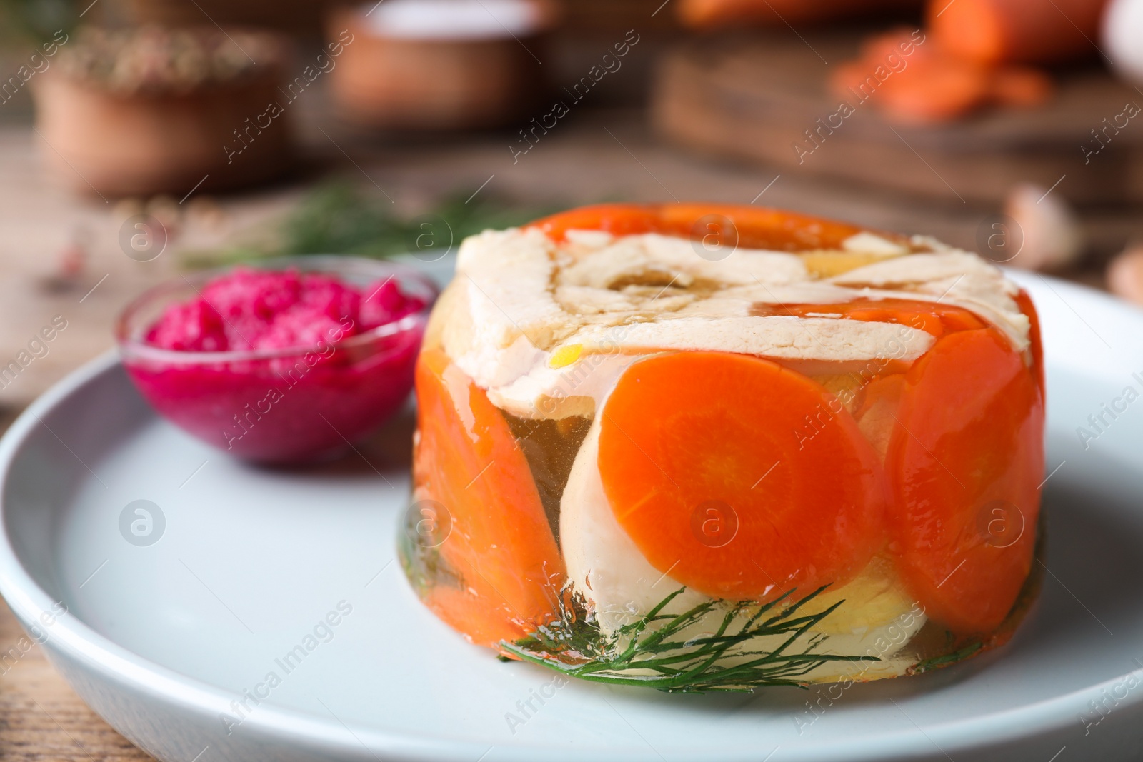 Photo of Delicious chicken aspic with vegetables on plate, closeup