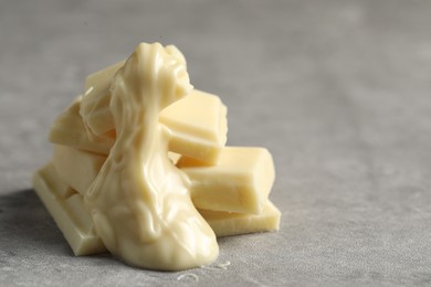 Pieces of white chocolate and tasty paste on grey table, closeup. Space for text