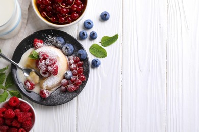 Photo of Delicious vanilla fondant served with berries on white wooden table, flat lay. Space for text