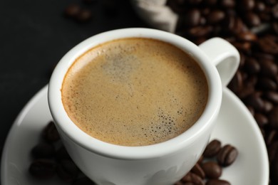 Cup of aromatic coffee on grey table, closeup