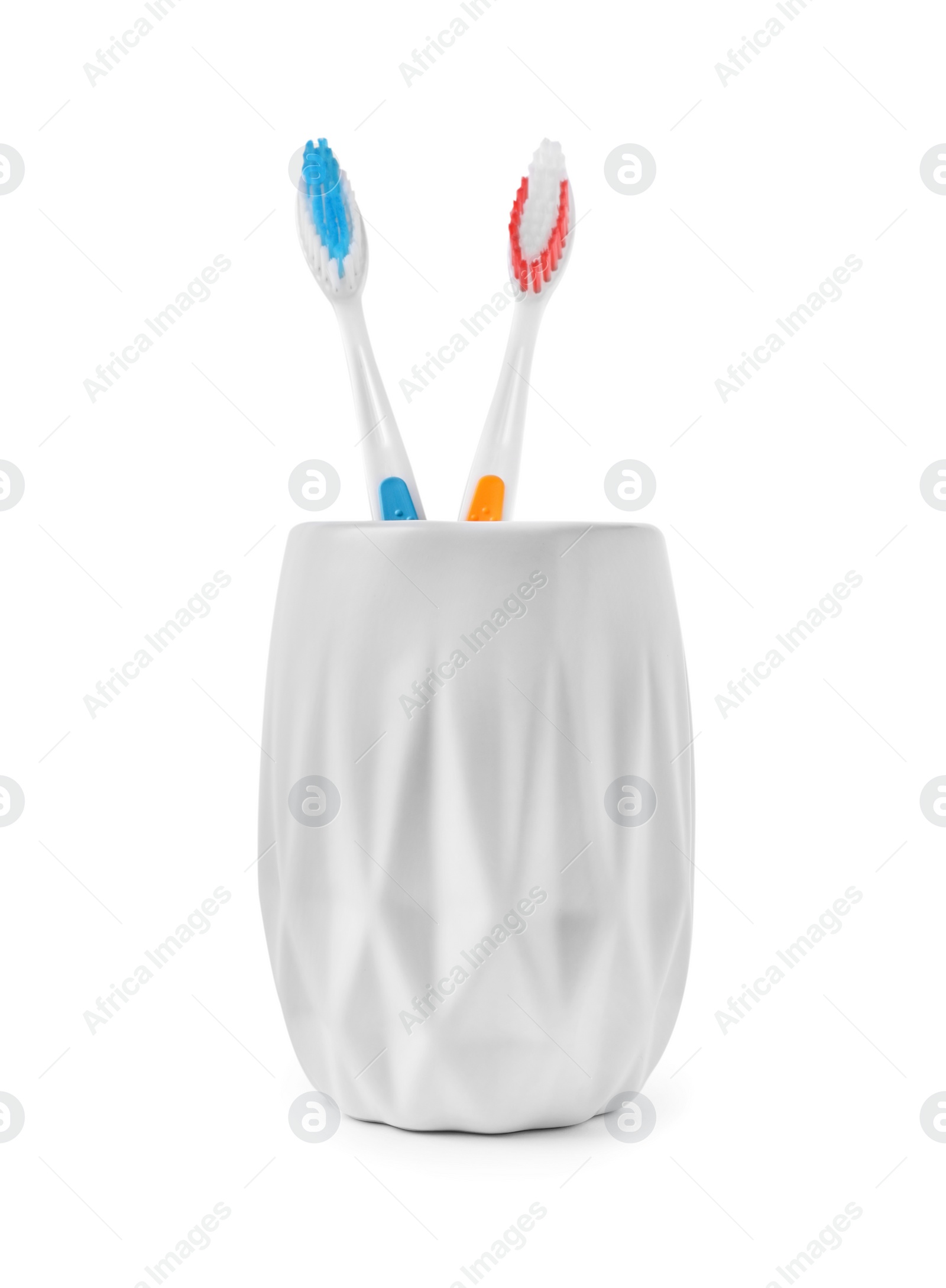 Photo of Bath accessories. Toothbrushes in holder isolated on white