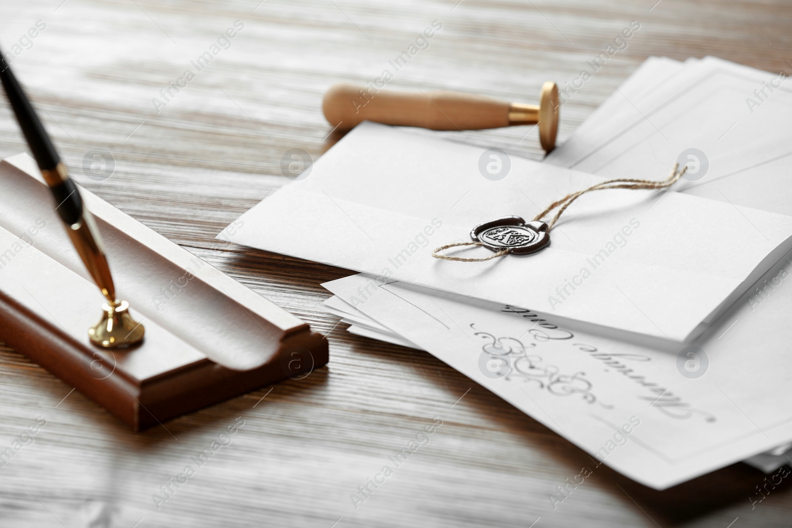 Photo of Notary stamp, pen and documents on wooden table