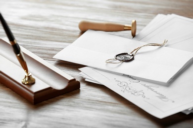 Notary stamp, pen and documents on wooden table